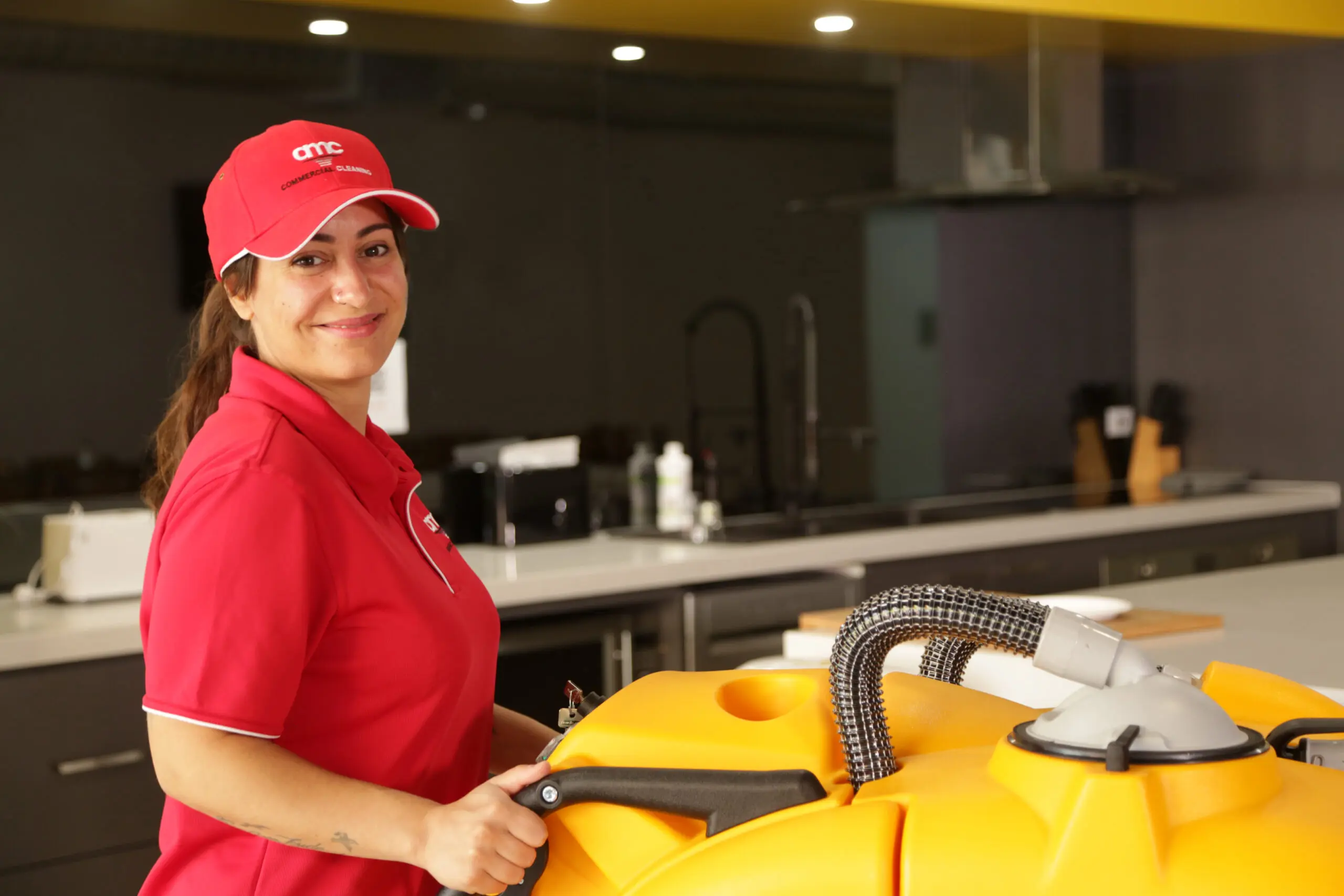 Cleaner with walk behind machine completing industrial cleaning shift