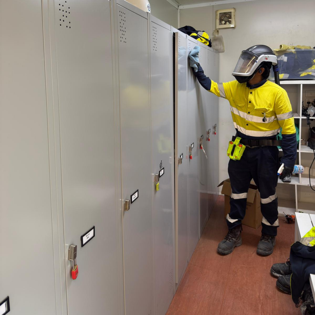 "Workers in protective gear, including Adflo respirators, operating safely in a challenging industrial environment, symbolising commitment to tailored safety protocols and a people-first approach."
