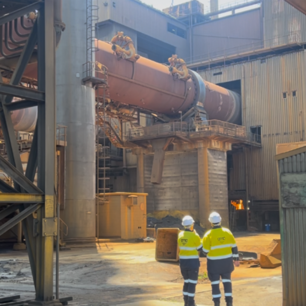 Steel plant workers in full PPE operating safely in a heavy industrial environment, highlighting strict safety protocols and a people-first approach.